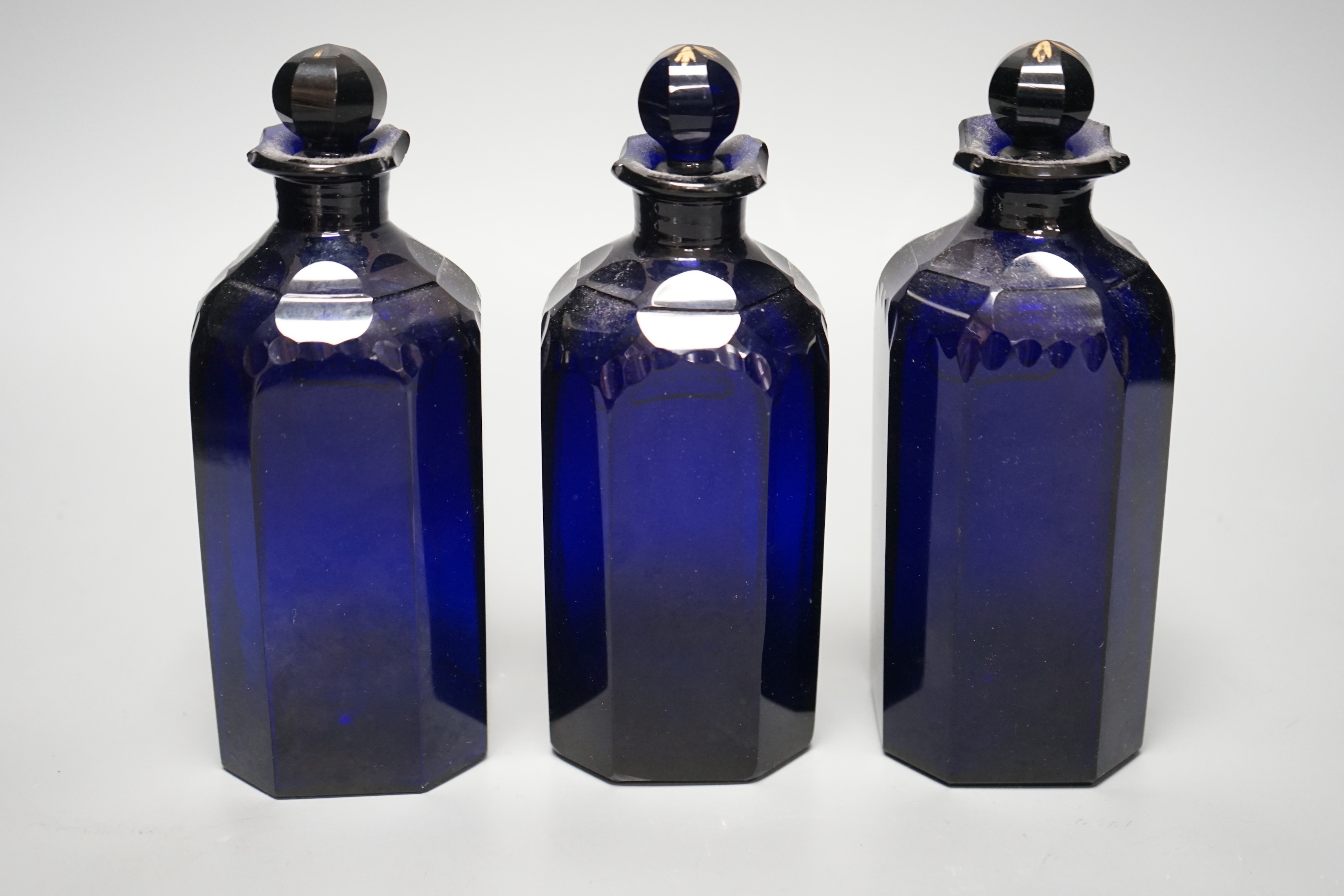 Three Georgian Bristol Blue gilt labelled decanters, ‘rum’, ‘brandy’ and ‘shrub’ 20cm
